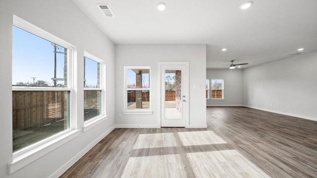 interior space with ceiling fan and light hardwood / wood-style floors