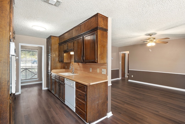 kitchen featuring sink, dishwasher, a textured ceiling, and dark hardwood / wood-style flooring