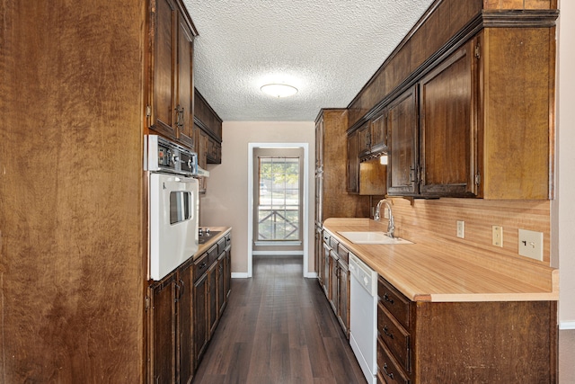 kitchen with white appliances, sink, backsplash, a textured ceiling, and dark hardwood / wood-style flooring