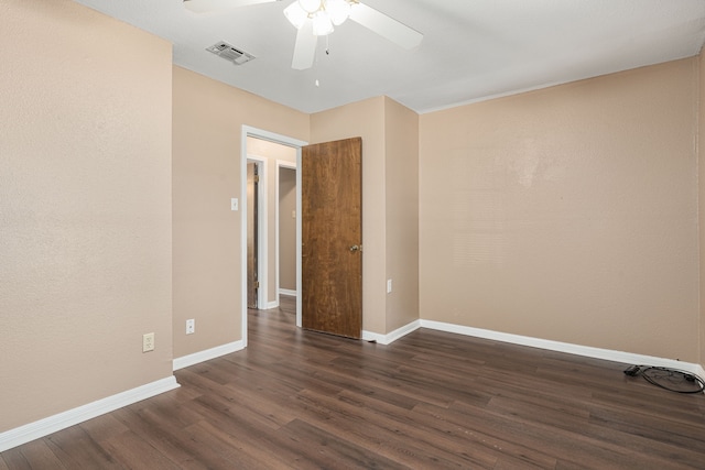 empty room featuring ceiling fan and dark hardwood / wood-style floors