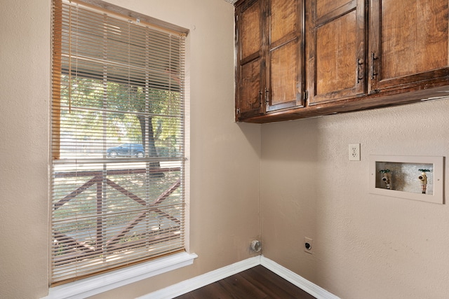 clothes washing area featuring cabinets, dark hardwood / wood-style flooring, washer hookup, and electric dryer hookup