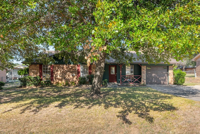 view of front facade with a front yard and a garage