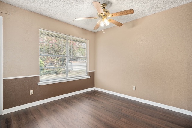 spare room with dark wood-type flooring, ceiling fan, and a textured ceiling