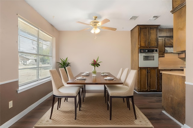 dining space with dark hardwood / wood-style floors and ceiling fan