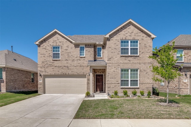 view of front of home with a garage and a front lawn