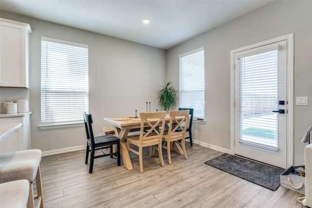 dining room with light wood-type flooring and a wealth of natural light