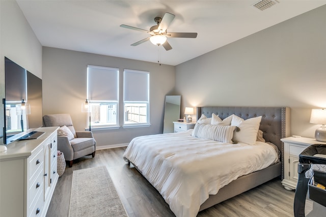 bedroom with ceiling fan and light hardwood / wood-style floors