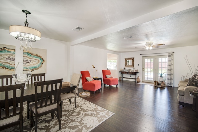 dining space with ceiling fan with notable chandelier, dark hardwood / wood-style flooring, french doors, and a textured ceiling