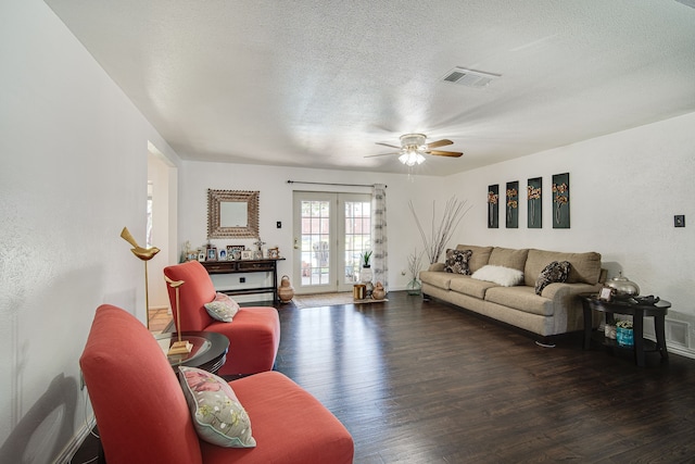 living room featuring ceiling fan, french doors, hardwood / wood-style flooring, and a textured ceiling