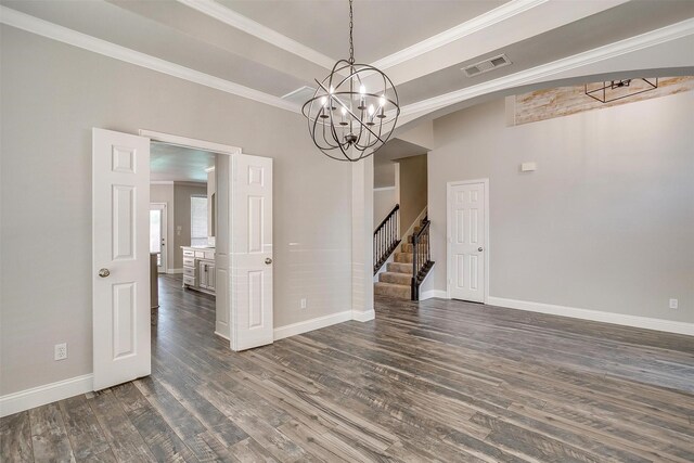 unfurnished room with ornamental molding, a notable chandelier, and dark hardwood / wood-style floors