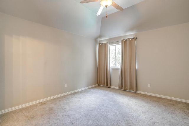 carpeted spare room featuring vaulted ceiling and ceiling fan