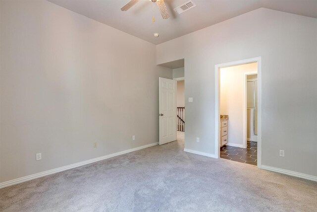 unfurnished bedroom featuring carpet flooring, ceiling fan, and vaulted ceiling