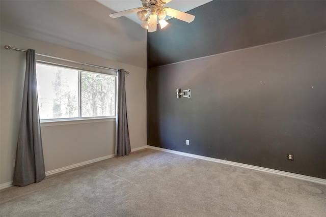 carpeted empty room with ceiling fan and vaulted ceiling