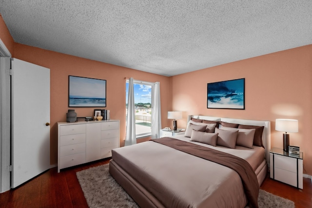 bedroom with a textured ceiling and hardwood / wood-style floors