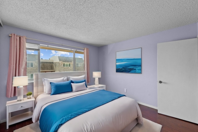 bedroom with a textured ceiling and hardwood / wood-style flooring