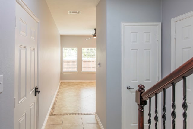 hall featuring light tile patterned floors