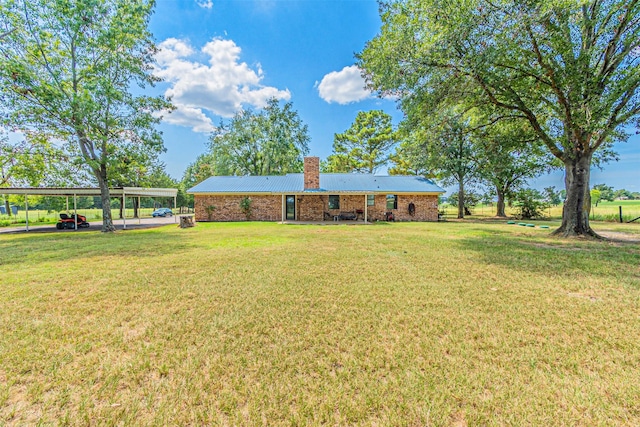 exterior space featuring a carport and a yard