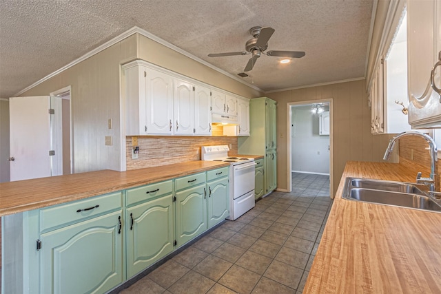 kitchen featuring sink, crown molding, tasteful backsplash, dark tile patterned floors, and white range with electric stovetop