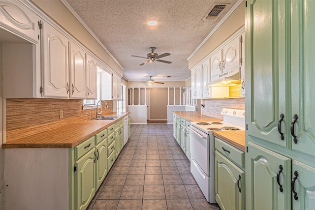 kitchen featuring sink, backsplash, electric range, white cabinets, and dark tile patterned flooring