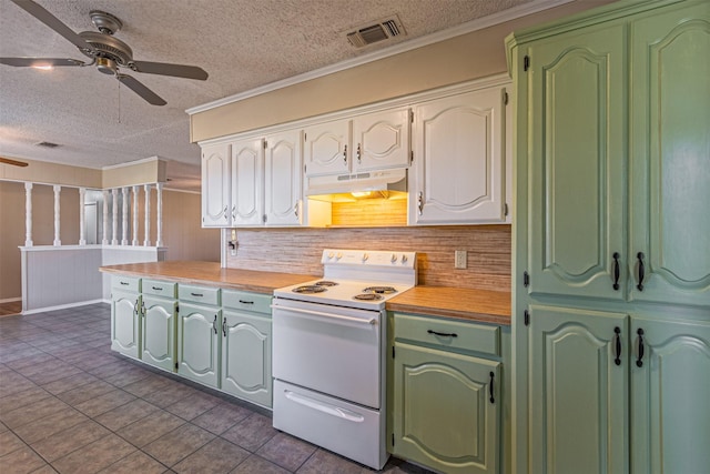 kitchen featuring electric range, ornamental molding, dark tile patterned floors, and white cabinets