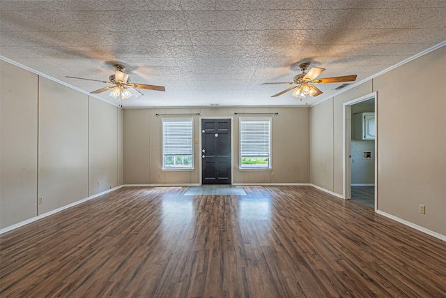 spare room with ornamental molding, dark hardwood / wood-style floors, a textured ceiling, and ceiling fan