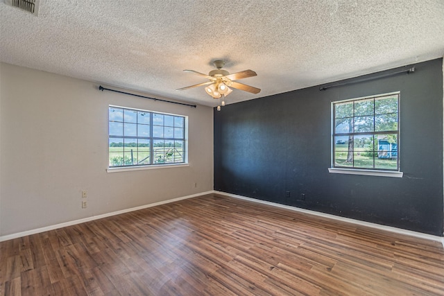 spare room with hardwood / wood-style flooring, a textured ceiling, and ceiling fan