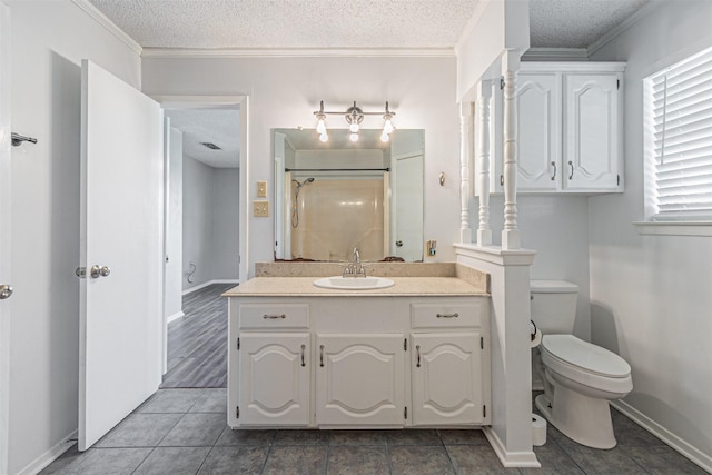 bathroom featuring crown molding, vanity, a textured ceiling, and a shower