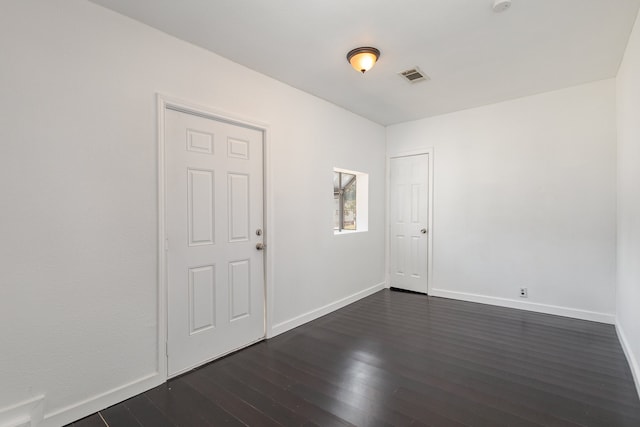 unfurnished room featuring dark hardwood / wood-style floors