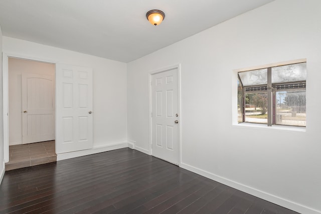 unfurnished room featuring dark hardwood / wood-style flooring