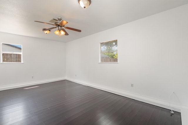 unfurnished room with ceiling fan and dark hardwood / wood-style flooring