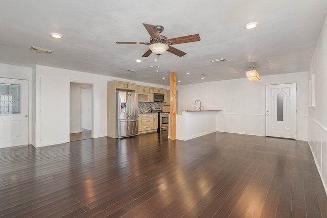 unfurnished living room featuring ceiling fan and dark hardwood / wood-style floors