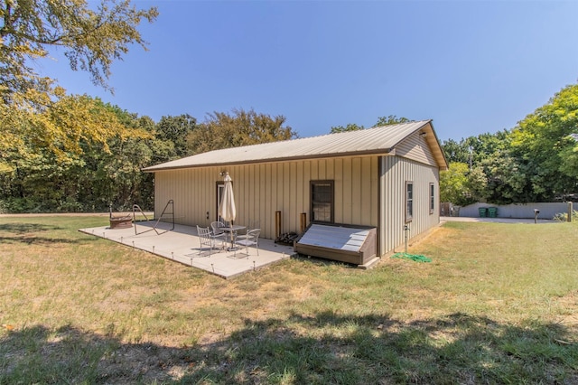 rear view of property with a lawn and a patio area