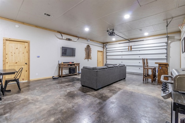 garage with a garage door opener and ceiling fan