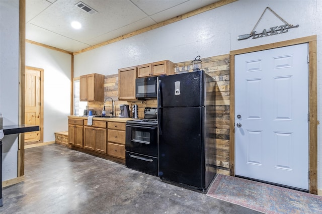 kitchen with black appliances, a paneled ceiling, decorative backsplash, and sink