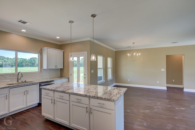 kitchen with dark hardwood / wood-style floors, white cabinetry, dishwasher, tasteful backsplash, and sink