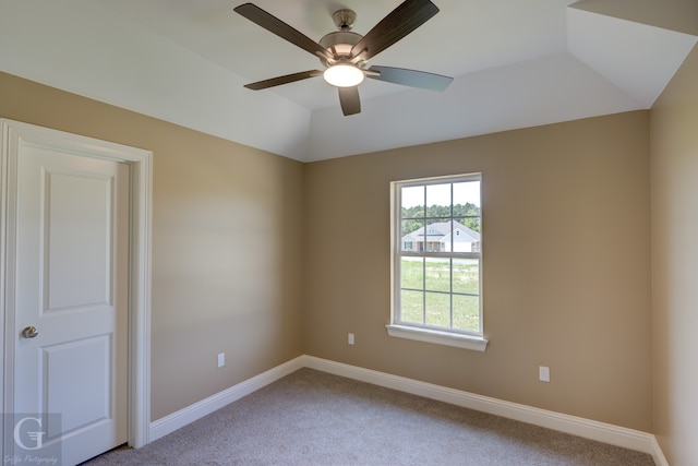 unfurnished room featuring ceiling fan, lofted ceiling, and light colored carpet