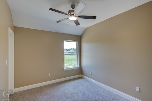 carpeted empty room with lofted ceiling and ceiling fan