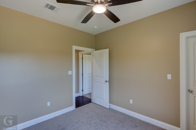 unfurnished bedroom featuring ceiling fan and carpet floors