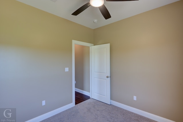 unfurnished room with ceiling fan and carpet flooring