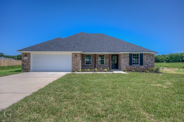 single story home featuring a front yard and a garage