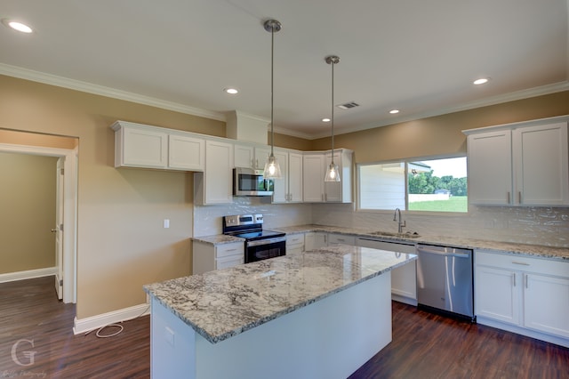 kitchen featuring decorative backsplash, appliances with stainless steel finishes, dark hardwood / wood-style floors, and hanging light fixtures