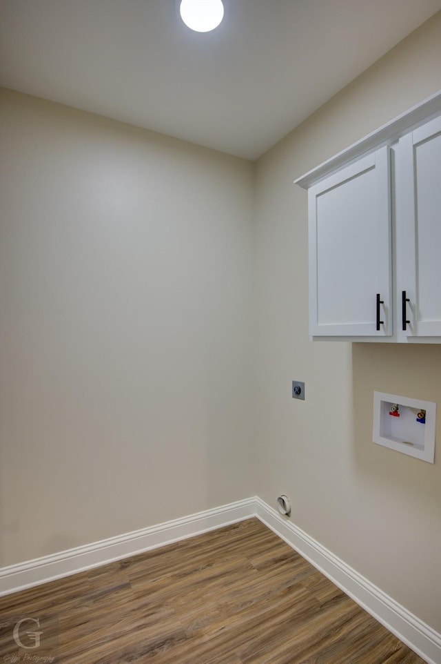 washroom with hardwood / wood-style floors, hookup for a washing machine, cabinets, and hookup for an electric dryer