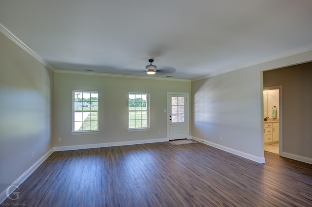 spare room with crown molding, dark wood-type flooring, and ceiling fan