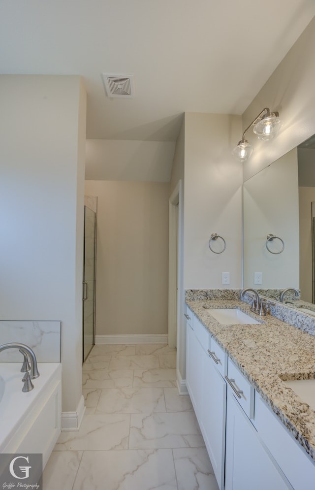 bathroom with double vanity, tile patterned flooring, and separate shower and tub