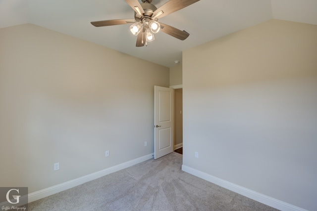 empty room with ceiling fan, light carpet, and vaulted ceiling