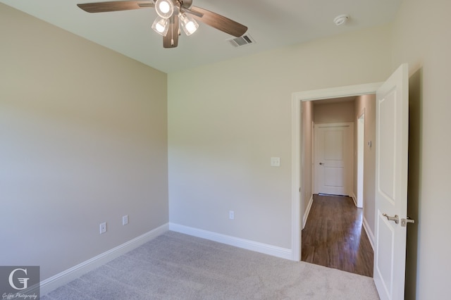 spare room featuring ceiling fan and carpet flooring