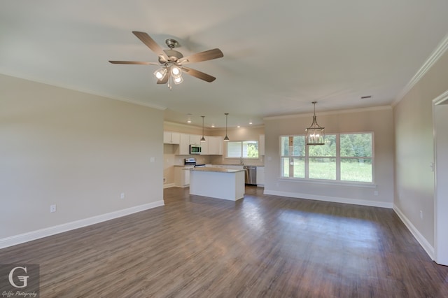 unfurnished living room with ceiling fan with notable chandelier, dark hardwood / wood-style flooring, ornamental molding, and sink