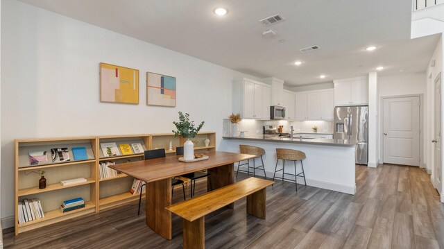 dining area featuring dark hardwood / wood-style flooring and sink