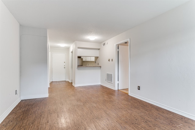 unfurnished living room with hardwood / wood-style floors