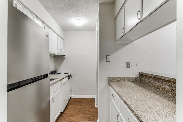 kitchen with white cabinets, dark wood-type flooring, a textured ceiling, and stainless steel refrigerator